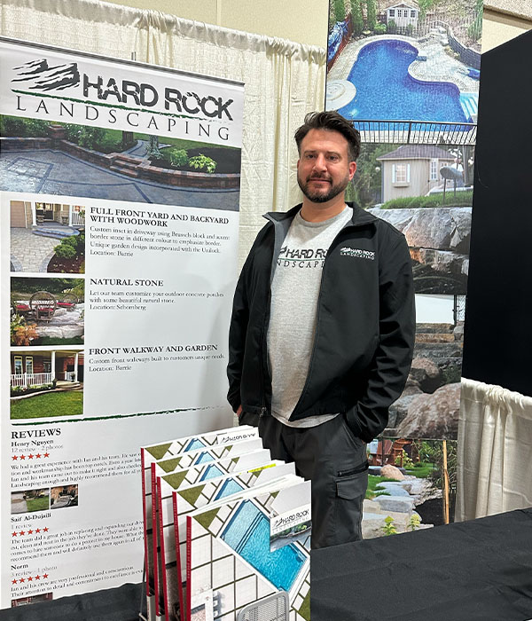 Man standing next to company poster