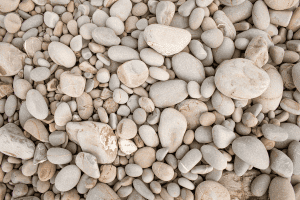 Smooth beige and gray pebbles on the ground