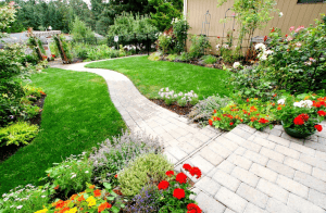 Garden with stone pathway and colorful flower beds.