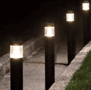 Row of modern bollard lights illumiating a walkway.